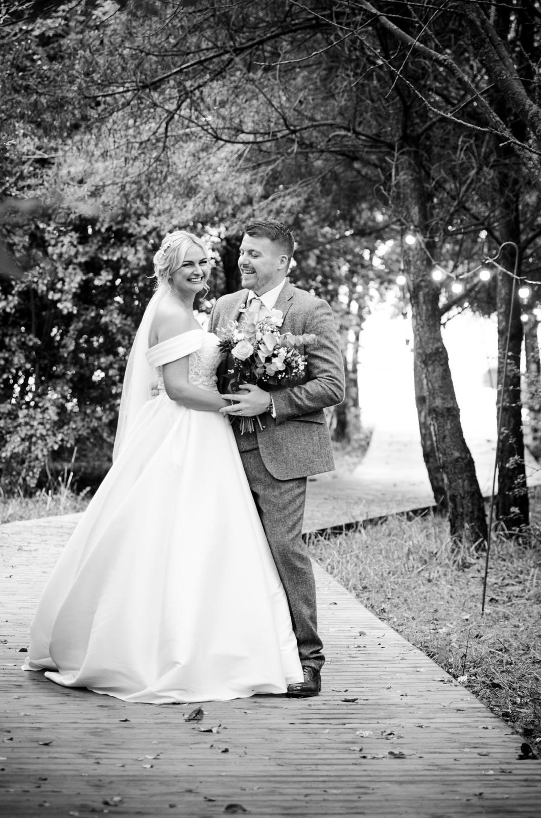 An outdoor wedding ceremony with guests gathered.
